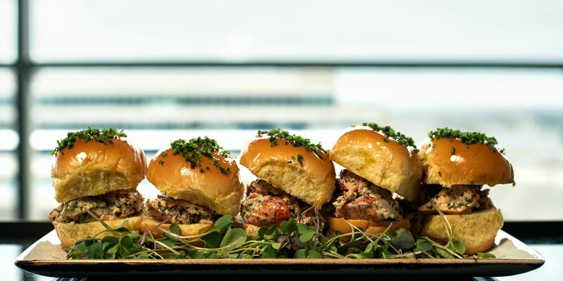 5 chicken sliders with slaw over a bed of greens